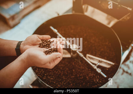 Professional coffee roasting and testing with hand in Colombia Stock Photo