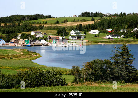 Boats and houses along the water in a quaint Canadian town. Stock Photo