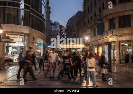 BELGRADE, SERBIA - APRIL 22, 2018: Kneza Mihailova street at night, crowded, with blurred people rushing. Also known as Knez Mihaila, this is the main Stock Photo