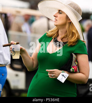 The Plains, Virginia/USA-5-19-17: Woman smokes a cigar at the Virginia Gold Cup. Stock Photo