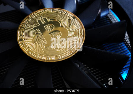 Cryptocurrency mining. Bitcoin BTC coin on a cooler. Stock Photo