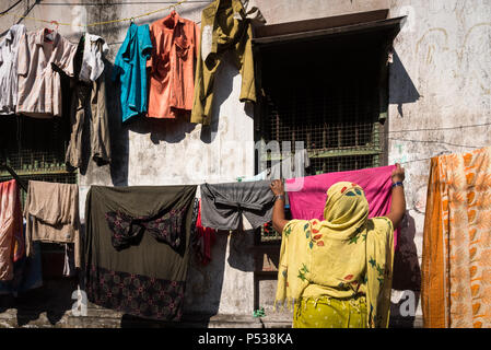 A woman hangs her wash out to dry in Kolkata, India. Stock Photo