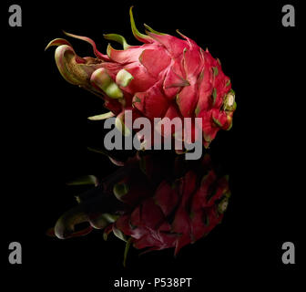 One red pitaya or dragon fruit isolated on black reflective background Stock Photo