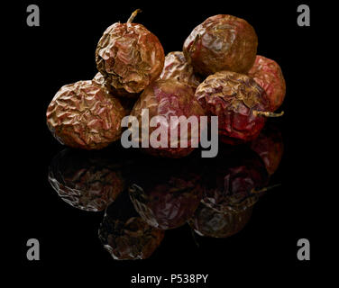 Heap of dried maracuya isolated on black reflective background Stock Photo