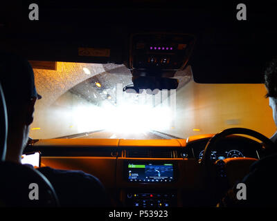 Two guys driving in their Range Rover through a long tunnel in France Stock Photo
