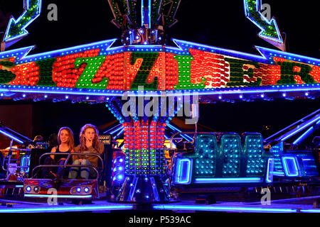 Two teenage girls on a fairground ride Stock Photo