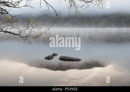 Early morning mist along the shore of Ullswater in the Lake District National Park Stock Photo