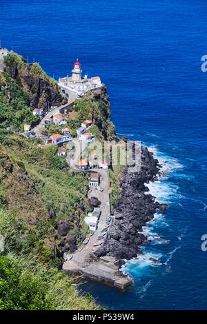 View to Azores lighthouse Ponta do Arnel from viewpoint (Europe, Portugal) Stock Photo