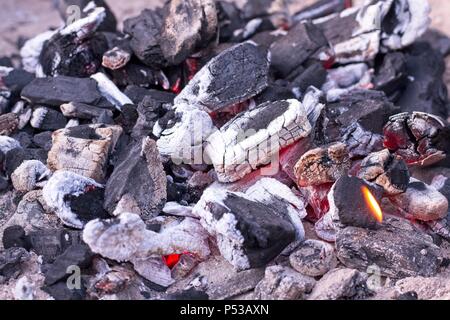 White hot lit embers of lump wood charcoal on a bbq. Stock Photo