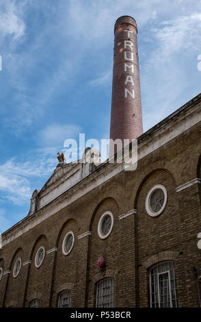 The Old Truman Brewery building on Brick Lane, East London UK, with iconic chimney, now used as a retail, leisure and business event space. Stock Photo