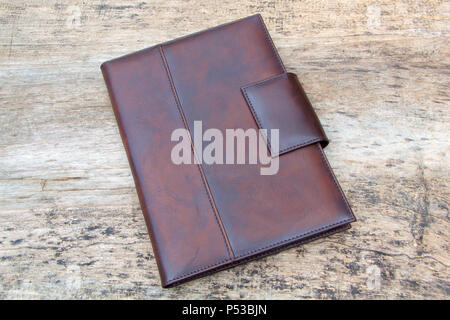 Brown leather organizer planner on the wooden backgrounde. Front and back side. Stock Photo