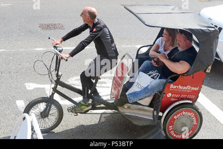 Glasgow Cycle Rickshaw rider, with two large people as customers, Scotland, UK Stock Photo
