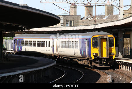 Class 156 super sprinter dmu in Northern livery arriving Carnforth railway station platform 1 with passenger service to Lancaster. Stock Photo