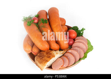 Sausages with green tomatoes and a slice of bread on a plate. Isolated white background. Stock Photo