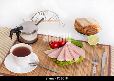 Sausage boiled with greens, tomatoes and cucumbers. Served with black or white bread. Sandwiches with sausage are an easy and healthy breakfast at the Stock Photo