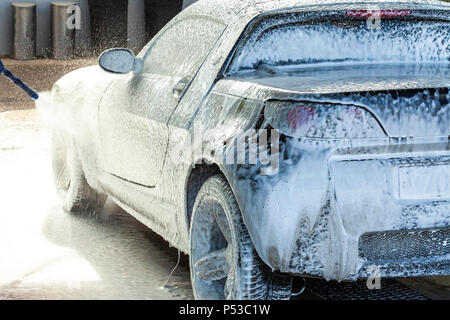 Outdoor car wash with active foam soap. commercial cleaning washing service  concept. Leave space to write messages. Stock Photo