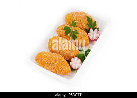 Freshly frozen semi-finished products. Cutlets from tender meat of chicken in a cover made of biscuits.  Isolate on white background. Stock Photo