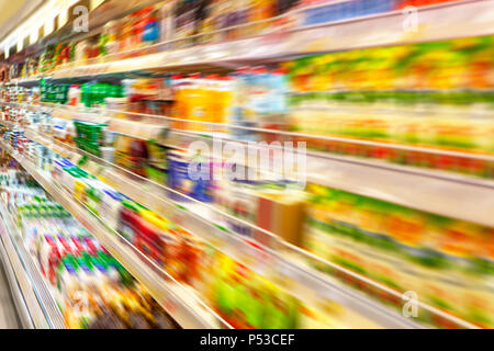 Blurred photos showcases shops. Long rows of racks with goods. Stock Photo