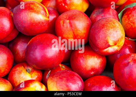 Bright nectarines in the market. Stock Photo