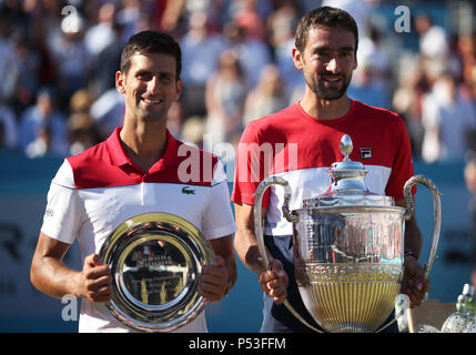 Winner Croatia's Marin Cilic (right) and Serbia's Novak Djokovic with the runners up trophy after the men's final during day seven of the Fever-Tree Championship at the Queen's Club, London. Stock Photo