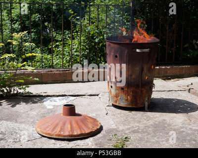 Burning bin incinerator fire Stock Photo - Alamy