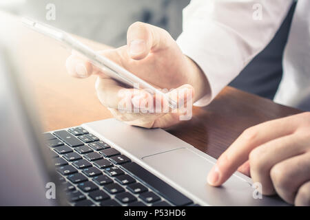 Businessman Working With Mobile And Notebook In Office Stock Photo