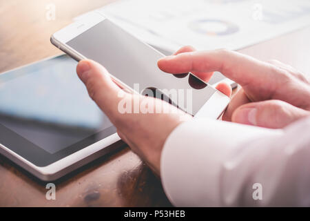 Businessman Analyzing Financial Statistics With Smartphone Stock Photo