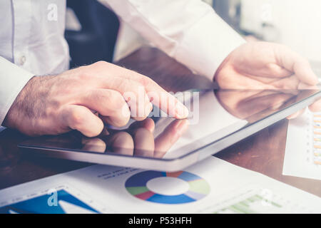 Businessman Analyzing Financial Statistics With Tablet Stock Photo