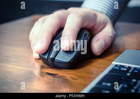 Man Using A Computer Mouse Next To A Laptop On A Table  Stock Photo