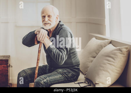Positive aged man resting at home Stock Photo