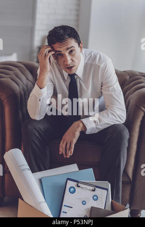 Cheerless young man looking at you Stock Photo