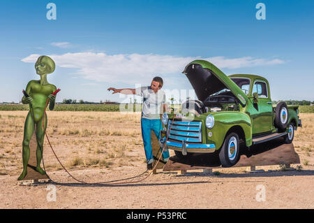 Roswell, New Mexico, USA, city limits a public art installation by John Cerney, depicts a local helping an alien jumpstart his flying saucer. Stock Photo