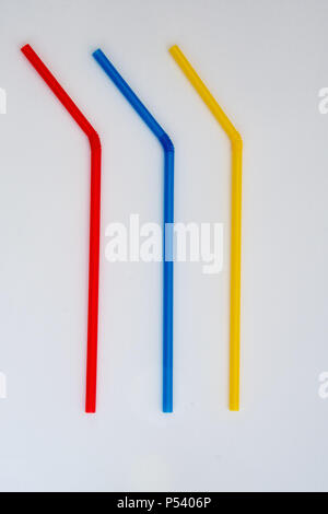 Three different coloured plastic drinking straws Stock Photo