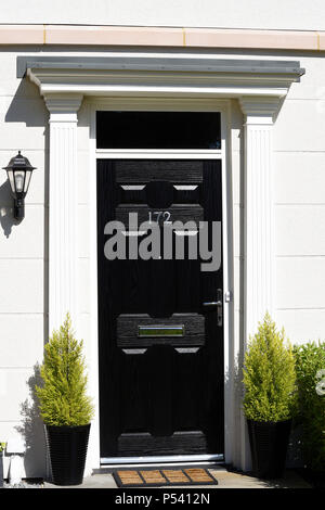 Black townhouse entrance front door on white building. Contrast. Black white. Home. House. Building. Thorpe Hall Avenue, Thorpe Bay, Southend, Essex Stock Photo