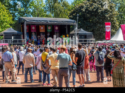 A large audience watching a Bhangra performance by the Gabru Punjab De Dancers at Glasgow Mela, 2018, in Kelvingrove Park in the city's West End Stock Photo