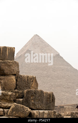 The Pyramid of Khafre (Chephren), the second-tallest of the Egyptian Pyramids of Giza, and stones of the Pyramid of Khufu (Cheops). Stock Photo