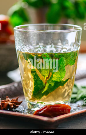 Traditional moroccan mint tea with dates on a vintage tray. White stone background. Close up. Stock Photo
