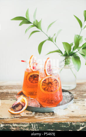 Two glasses of Italian Aperol spritz alcohol cocktail with ice and blood orange slices. Summer refreshing cocktail drink Stock Photo