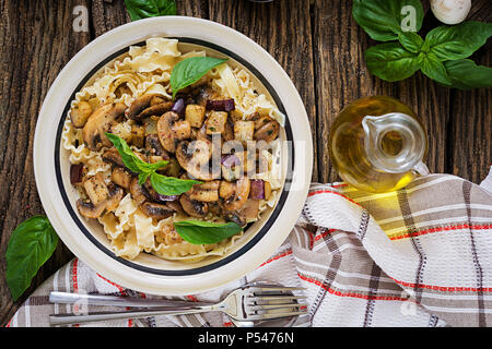 Vegetarian pasta with mushrooms and aubergines, eggplants. Italian food. Vegan meal. Top view. Flat lay. Stock Photo