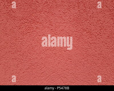 red wall background. The texture of the plaster under the paint is clearly visible Stock Photo