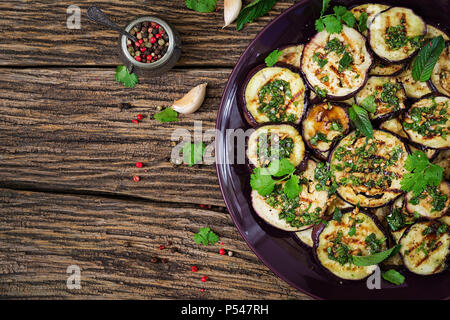 Eggplant grilled with balsamic sauce, garlic, cilantro and mint. Vegan food. Grilled aubergine. Top view. Flat lay Stock Photo