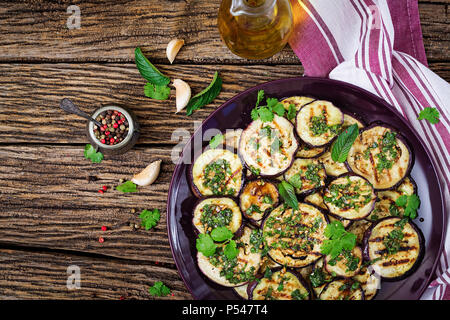 Eggplant grilled with balsamic sauce, garlic, cilantro and mint. Vegan food. Grilled aubergine. Top view. Flat lay Stock Photo