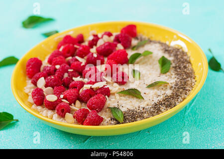 Tasty and healthy oatmeal porridge with raspberry and flax chia. Healthy breakfast. Fitness food. Proper nutrition Stock Photo