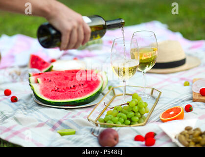 Picnic background with white wine on green grass close-up Stock Photo