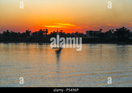 Sunset on the Nile River with Felucca boat sailing, Luxor, Egypt, Africa Stock Photo