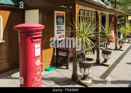 Old Edward VII post box outside the cafe and station booking office. Laxey, Isle of Man, British Isles Stock Photo