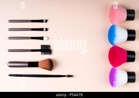 Cosmetics accessories for makeup on beige background flat lay. Set of cosmetics brushes. Minimal composition. Fashion and beauty blogging concept. Top Stock Photo