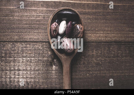 Organic Colorful Beans and Wooden Spoon on Dark Background Stock Photo