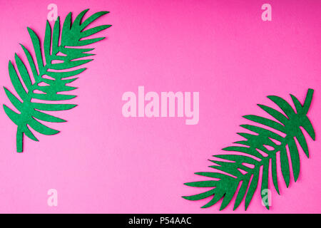 Creative summer trendy background with palm leaves on pink. Handmade palm leaves. Idea summer art crafts for kids in camp arts. Top view Stock Photo