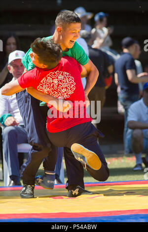 KAZAN, RUSSIA - JUNE 23, 2018: Traditional Tatar festival Sabantuy - Two male teenagers fighting in folk wrestling kuresh Stock Photo